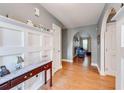 Hallway featuring arched doorways, hardwood floors, and decorative wainscoting at 1720 Alcovy River Dr, Dacula, GA 30019