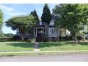 Charming two-story home with a brick stairway, landscaped front yard, and inviting front porch at 1699 Little Fox Ln, Dacula, GA 30019