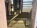 Unique foyer featuring an elaborate wrought iron banister and a full suit of armor at 209 Kingscastle Dr, Ellenwood, GA 30294