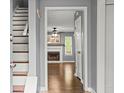 Entryway with hardwood floors leads to a living room and staircase with white risers and a gray frame at 855 Cedar Bluff Ct, Marietta, GA 30062