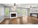 Bright living room with hardwood floors, fireplace, a ceiling fan, and access to a patio with lovely natural light at 855 Cedar Bluff Ct, Marietta, GA 30062