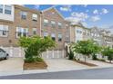 Charming brick townhome featuring a two-car garage and well-maintained landscaping at 1327 Rosen Rd, Brookhaven, GA 30319