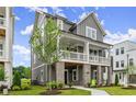 Stylish two-story home shows a side view with a gray exterior and manicured lawn at 1419 Coretta Bnd, Atlanta, GA 30318