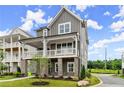 Attractive home featuring a covered porch, gray siding, and manicured landscaping at 1419 Coretta Bnd, Atlanta, GA 30318