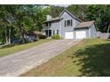 Charming two-story home featuring a two-car garage, second story balcony, and long driveway on a large lot at 4971 Sharp Way, Duluth, GA 30096