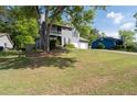 Two-story home featuring a two-car garage, second story balcony and a spacious yard with mature shade trees at 4971 Sharp Way, Duluth, GA 30096