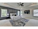 This bedroom boasts a tray ceiling, paneled accent wall, and plush rug at 11305 Knollwood Bend, Johns Creek, GA 30097