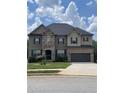 Charming two-story home with a well-manicured lawn, stone and brick facade and a two car garage at 292 Aylesbury Bv, Mcdonough, GA 30252