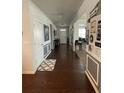 Inviting hallway featuring hardwood floors, decorative wainscoting, and a view of the home's entryway at 292 Aylesbury Bv, Mcdonough, GA 30252
