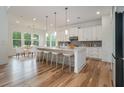 Well-lit kitchen featuring an island with seating, stainless steel appliances, and an adjacent dining area at 4039 Tallow Pl, Woodstock, GA 30188
