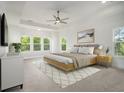 Spacious main bedroom features tray ceilings, large windows, and a ceiling fan at 4039 Tallow Pl, Woodstock, GA 30188