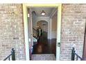 View through the front door into a well-lit foyer with hardwood floors and a staircase at 7165 Winthrop Rd, Alpharetta, GA 30005