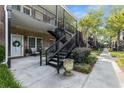 Exterior of a brick building with a white door, small patio and black metal staircase at 3675 Peachtree Ne Rd # 9, Atlanta, GA 30319