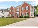Stunning red brick home with an attached garage and lush green lawn at 3720 Bridle Ridge Dr, Suwanee, GA 30024