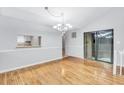 Dining room with wood floors, decorative chandelier, and sliding glass doors at 1668 Terrell Ridge Se Dr, Marietta, GA 30067