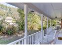 Inviting covered front porch with white railings and rocking chairs, offering a relaxing outdoor space at 4092 Deerbrook Sw Way, Lilburn, GA 30047