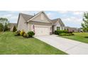 Well-manicured front yard with a two-car garage and charming exterior details at 5775 Stellata Cir, Cumming, GA 30028
