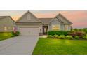 Charming home featuring a well-manicured lawn, a two-car garage, and an inviting entryway at 5775 Stellata Cir, Cumming, GA 30028