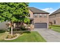 Inviting brick home with a covered porch, mature tree, and a well-maintained lawn at 1212 Overlook Lake Dr, Dacula, GA 30019