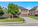 Charming two-story brick home with a well-kept lawn, mature tree, and a welcoming covered front porch at 1212 Overlook Lake Dr, Dacula, GA 30019