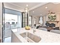 Bright kitchen showcasing stainless steel sink, granite countertop, and an open view to the living area at 1415 Coretta Bnd, Atlanta, GA 30318