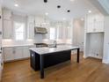 White gourmet kitchen features center island with white countertops and stainless steel appliances at 1415 Coretta Bnd, Atlanta, GA 30318