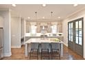 Open kitchen featuring a central island with seating, stainless steel appliances, and hardwood floors at 1415 Coretta Bnd, Atlanta, GA 30318