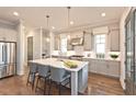 Spacious kitchen with granite countertops, modern appliances, hardwood floors, and pendant lighting at 1415 Coretta Bnd, Atlanta, GA 30318