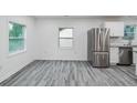 Bright kitchen featuring white cabinets, stainless steel appliances, and wood plank flooring at 1482 Connally Sw Ave, Atlanta, GA 30310