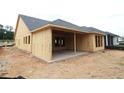 Image shows home under construction; view of the unfinished exterior elevation and covered patio at 251 Strawberry Ln, Woodstock, GA 30189
