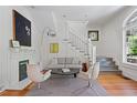 Cozy living room featuring a fireplace, a staircase, and stylish decor, creating a welcoming atmosphere at 872 Euclid Ne Ave, Atlanta, GA 30307