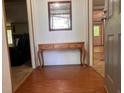 Inviting entryway with hardwood flooring, a decorative table and mirror, leading into the home's living spaces at 148 Boogers Hill Rd, Oxford, GA 30054