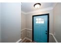 Close up of the light blue front door with trim and a view into the entryway at 1616 W Kellogg Cir, Douglasville, GA 30134
