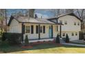 Inviting home featuring a covered front porch and landscaped front yard at 1616 W Kellogg Cir, Douglasville, GA 30134