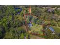 Aerial view of property showcasing the home's location within a beautifully wooded lot at 3919 Mccullers Rd, Loganville, GA 30052