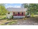 Charming home with a lovely red-railed front porch perfect for enjoying the outdoors at 3919 Mccullers Rd, Loganville, GA 30052