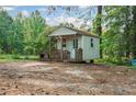 Exterior view of a quaint shed with a porch, providing extra storage or workspace at 3919 Mccullers Rd, Loganville, GA 30052
