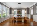 Bright dining room features a wooden table and bench, hardwood floors, and large windows that provide great light at 2685 Grady Se St, Smyrna, GA 30080