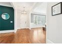 Inviting foyer with hardwood floors, white trim, and stylish decor leading to dining area at 2685 Grady Se St, Smyrna, GA 30080