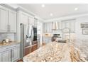 Bright kitchen with granite countertops, stainless steel appliances, and modern gray cabinetry at 2685 Grady Se St, Smyrna, GA 30080