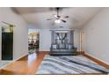 Cozy living room featuring hardwood floors, neutral paint, and an elegant ceiling fan at 5069 Luxford Dr, Douglasville, GA 30135