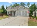 Charming one-story home with manicured lawn and cozy front porch seating at 52 Lantern Trce, Hiram, GA 30141