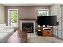 Bright living room with a fireplace, TV, and sliding glass doors at 5626 River Heights Se Xing, Marietta, GA 30067