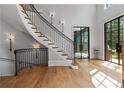 Elegant foyer showcasing a curved staircase with iron railings and hardwood floors at 6515 Ashbourne Ct, Suwanee, GA 30024