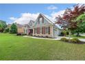 Inviting single-Gathering home featuring stone accents, a well-manicured lawn, and an attached garage at 17 Lexington Ct, Dallas, GA 30157