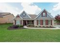 Charming single-Gathering home featuring stone accents, a well-manicured lawn, and a cozy, inviting entrance at 17 Lexington Ct, Dallas, GA 30157