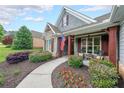 Inviting front porch featuring stone accents and a charming walkway surrounded by lush landscaping at 17 Lexington Ct, Dallas, GA 30157