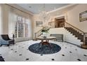 Grand foyer with elegant chandelier, staircase, and tiled flooring at 175 15Th Ne St # 304, Atlanta, GA 30309