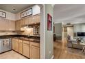 Functional kitchen with light wood cabinets, granite countertops, and open view to the living room at 175 15Th Ne St # 304, Atlanta, GA 30309