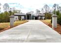 Beautiful modern home featuring a long driveway, stone entry posts and a sleek, minimalist design at 0 Highway 279, Fayetteville, GA 30214
